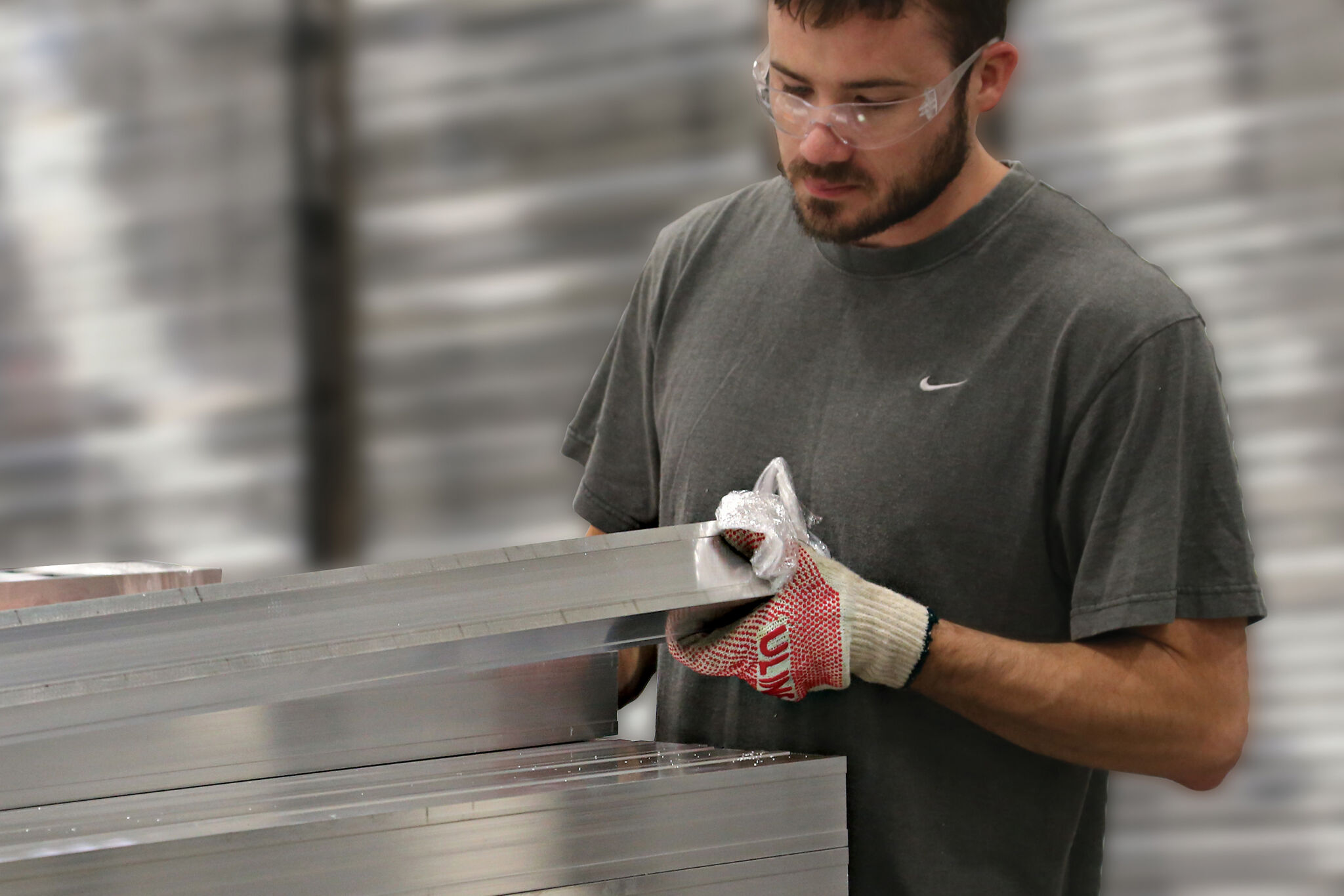 man holding fencing material